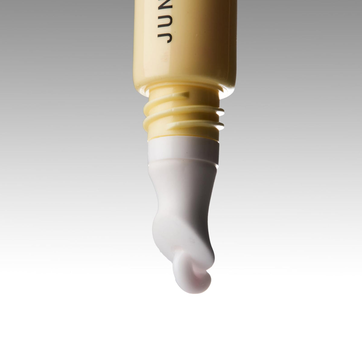 JUNO and Co Lip Milk nourishing beads close-up ready to melt into lips.