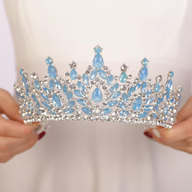 JWICOS blue rhinestone tiara shines under stage lighting.