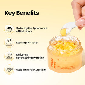 Vitamin C capsules visible within the cream for brightening potential.