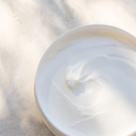 Kai body butter bottle highlights shea butter and plant-based, vegan formula.