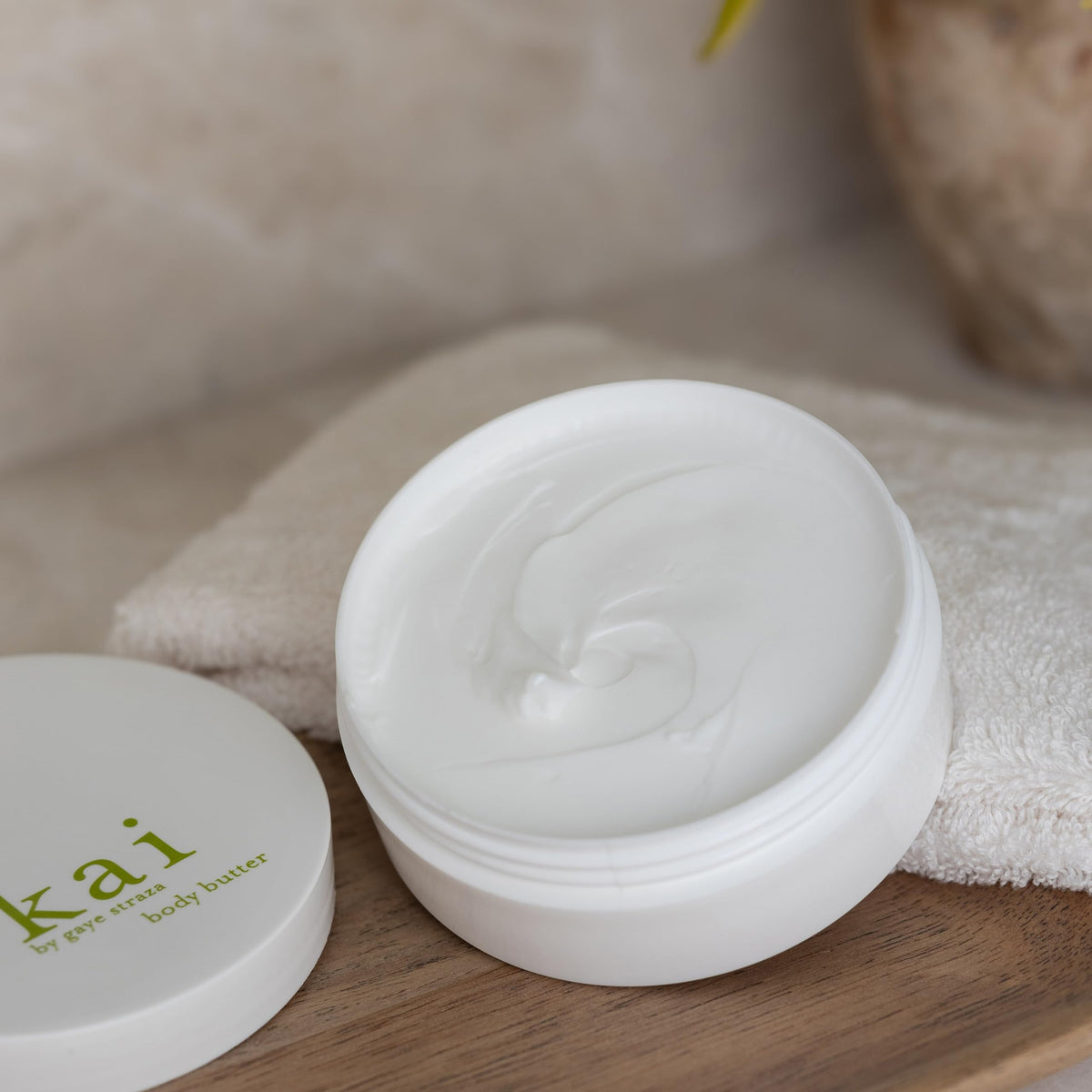 Kai body butter jar cap shows vitamins A, C, and E for skin health.