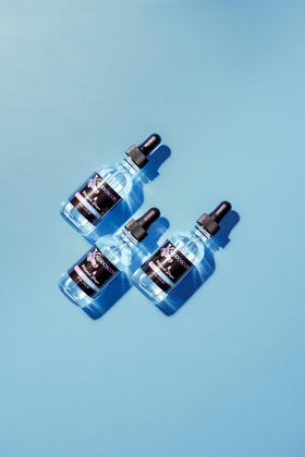 Kaleidoscope Miracle Drops bottle with dropper applying cooling relief.