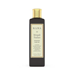 Kama Ayurveda Bringadi Tailam packaging closeup highlighting natural hair care benefits.