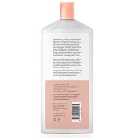 KAMEDIS conditioner bottle being held for easy daily use.