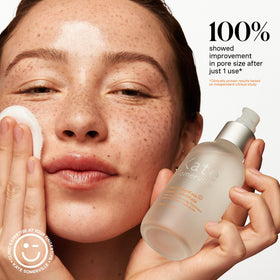 Cotton round applying Kate Somerville Liquid ExfoliKate to neck and jawline