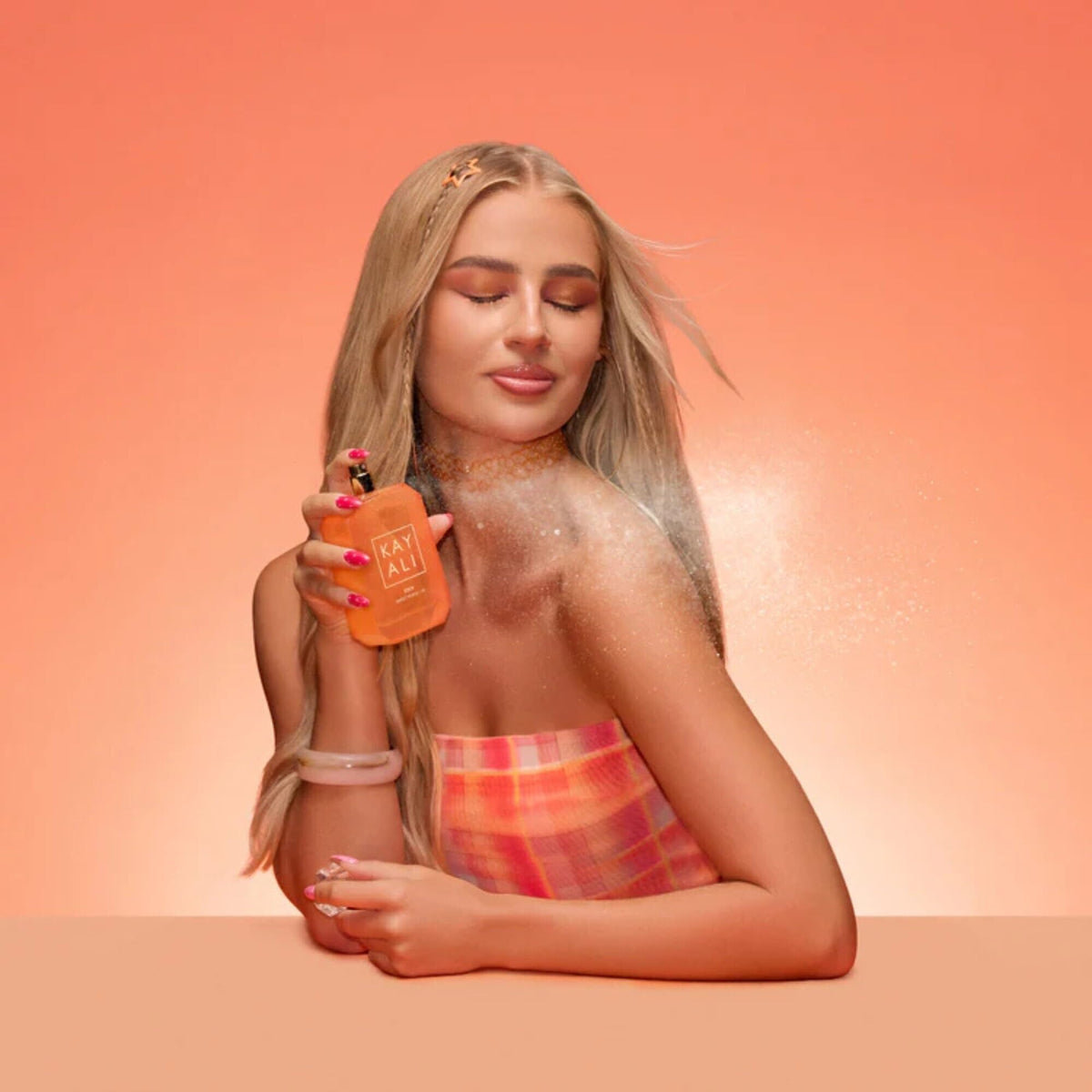 Kayali Eden Sweet Peach elegant glass bottle with spray for precise application