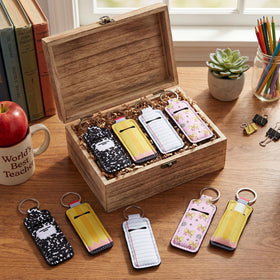 Kenning lip balm sleeve keychain on bag; keeps lip care handy.