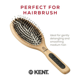 Kent PF01 compact 7-inch travel brush in hand for on-the-go styling.