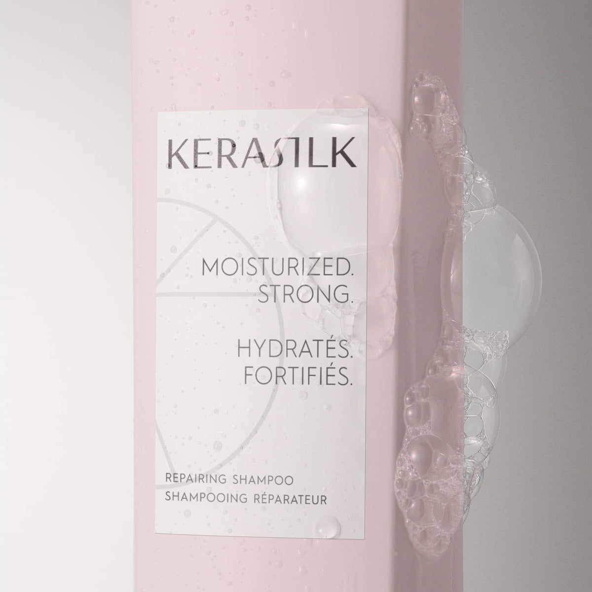 Kerasilk Repairing Shampoo foam close-up, creamy lather cleanses gently.
