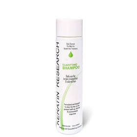 KERATIN RESEARCH clarifying shampoo bottle being poured for keratin treatments.