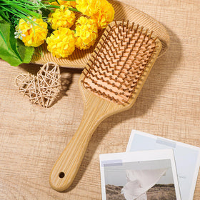 Kifmurase portable bamboo hair brush fits in a bag for travel touch-ups.