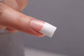 KISS Salon Acrylic French nude-tip nails with skin-tone finish for versatile everyday wear.