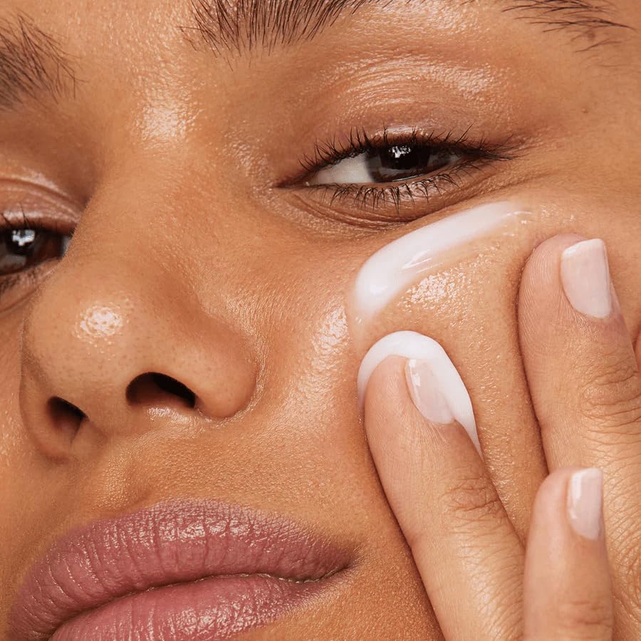 Kleem Organics under eye cream being applied with gentle fingertip motion.