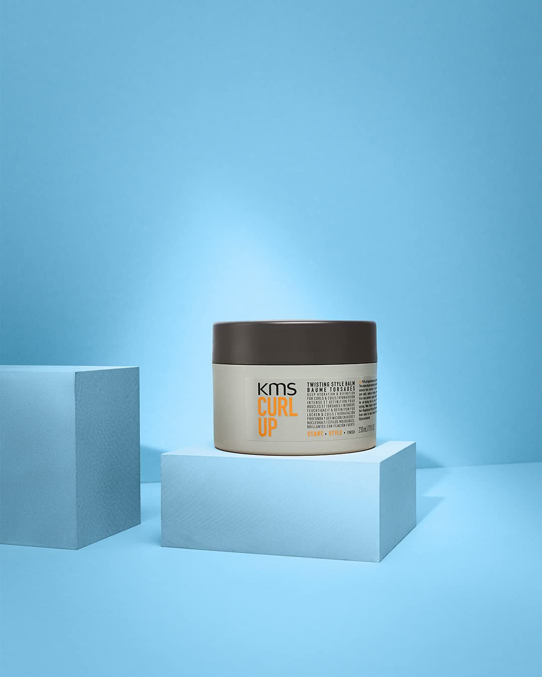 KMS CURLUP twisting style balm label detail emphasizes frizz control potential for curls