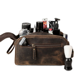 KomalC travel toiletry bag premium buffalo leather texture with detailed stitching.