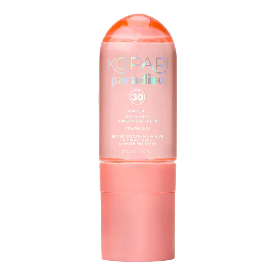 Kopari Paradiso Sun Juice SPF 30 bottle on a sunlit beach for easy SPF application.