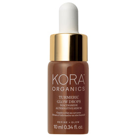 KORA Organics Turmeric Glow Drops bottle on a clean surface for radiant skin.
