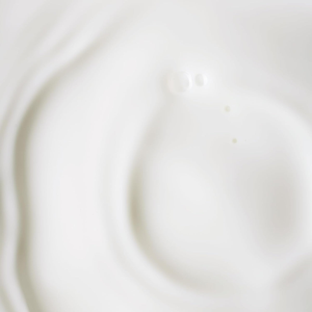 Close-up dropper releasing serum for gentle daily anti-aging routine.