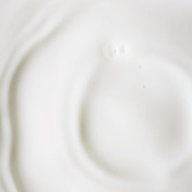 Close-up dropper releasing serum for gentle daily anti-aging routine.