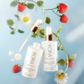 KORA Organics Silky Sun Drops being applied over makeup for mid-day reapplication