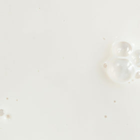 KORA Organics Silky Sun Drops serum texture close-up highlighting lightweight blendability