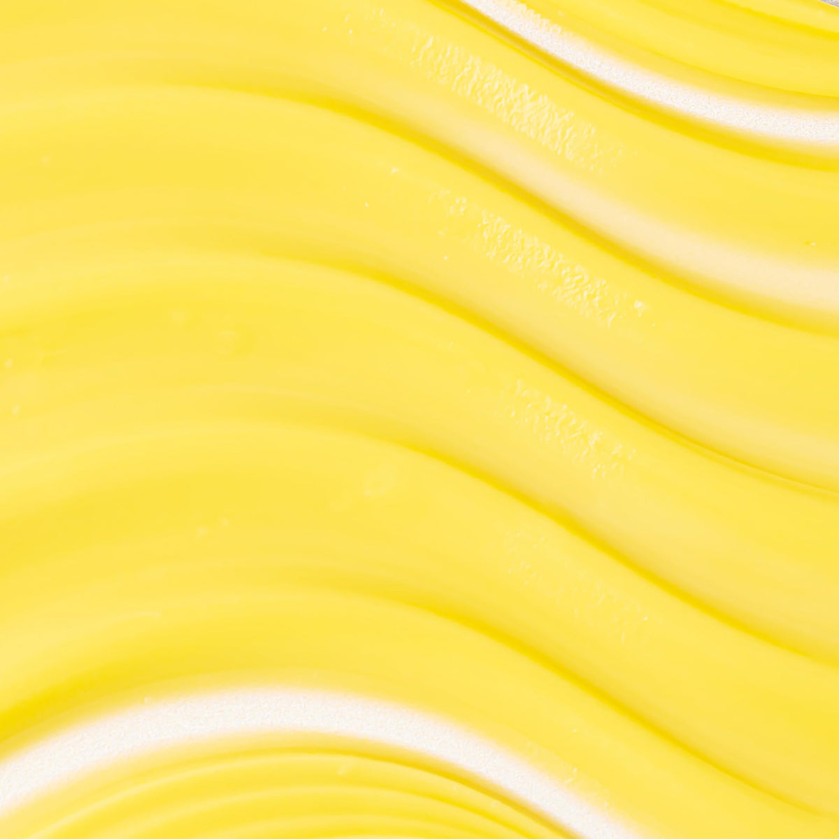 Texture close-up of KORA Turmeric Glow cream showing rich hydration.