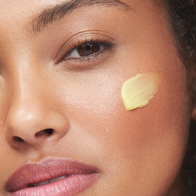 Model applying Turmeric Glow during daily skincare routine