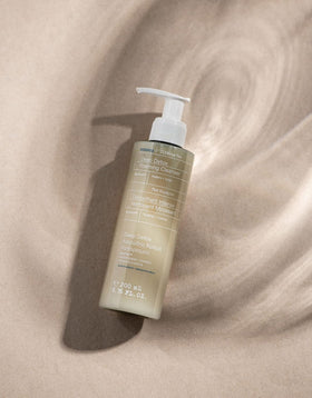 KORRES Olympus Tea Cleanser foamy lather on the face for makeup removal.