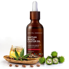 Kreyol Essence Haitian Black Castor Oil bottle close-up preparing for scalp moisturization.