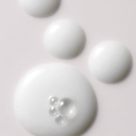 Kristin Ess Milk Oil dispenser in action for scalp nourishment