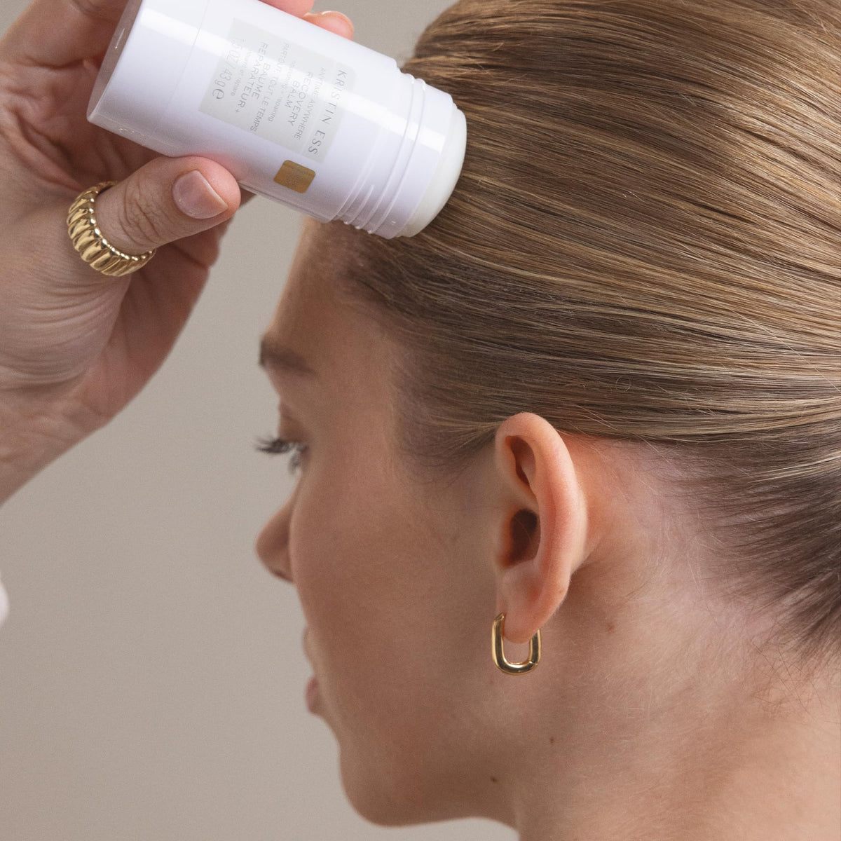 Taming flyaways with Kristin Ess Recovery Balm on dry damaged hair.