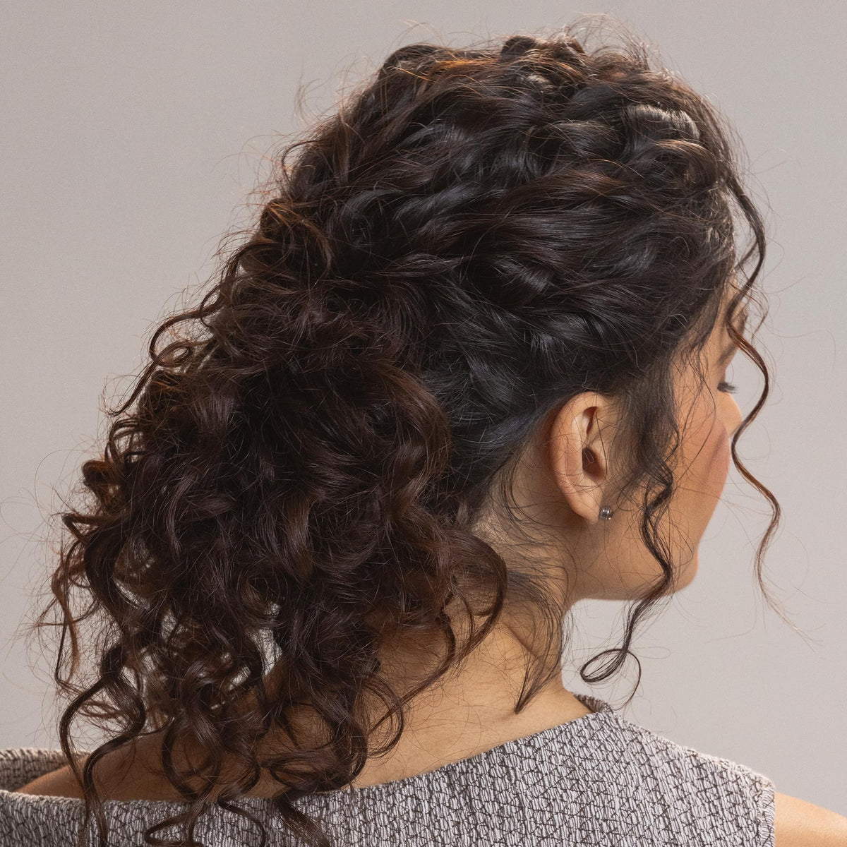 Kristin Ess Moisture Rich Curl Conditioner tube detangles and softens waves with frizz control.