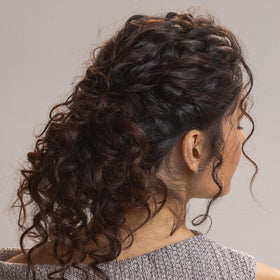 Kristin Ess Moisture Rich Curl Conditioner tube detangles and softens waves with frizz control.