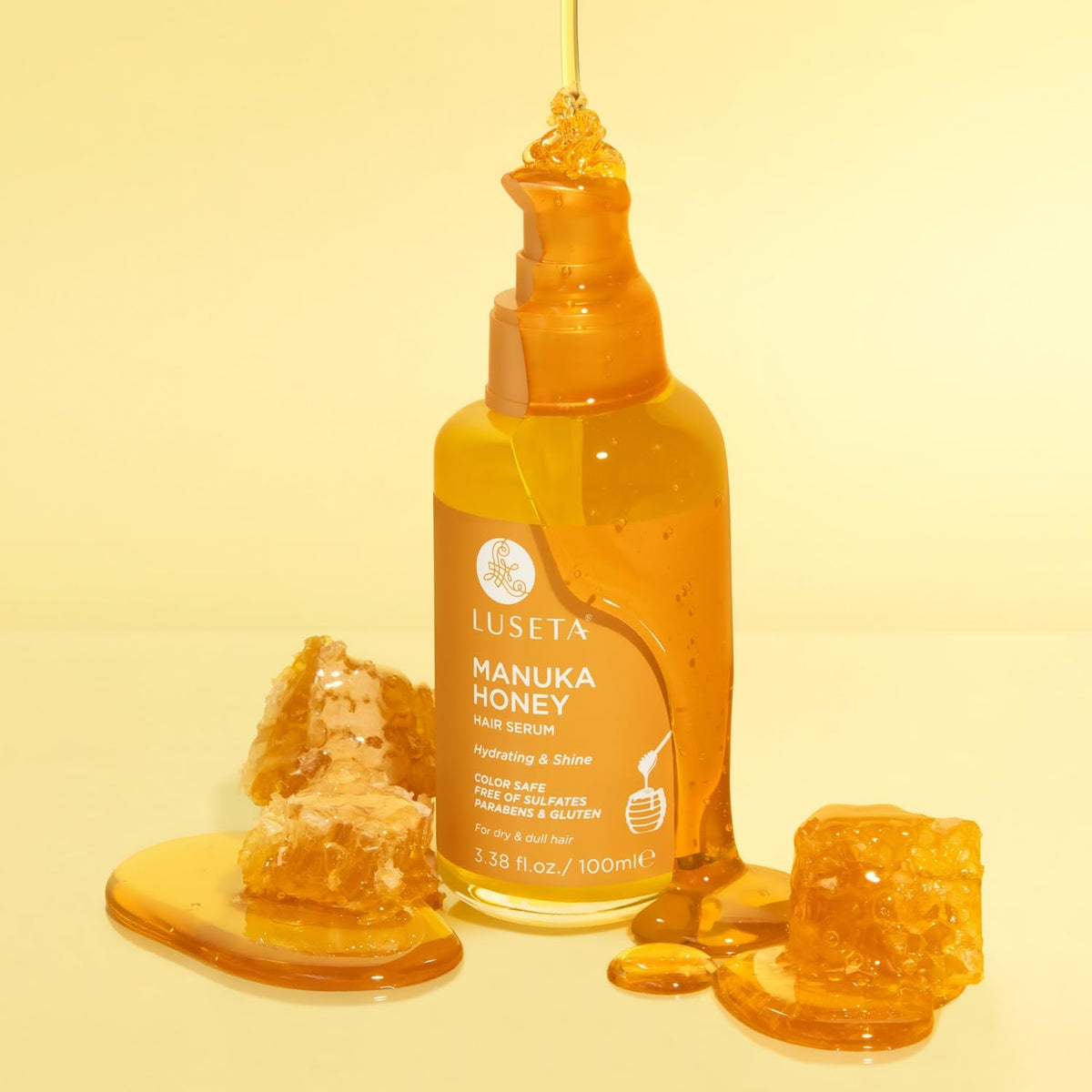 L LUSETA Manuka Honey Hair Oil argan oil droplets spreading through frizz-prone hair.