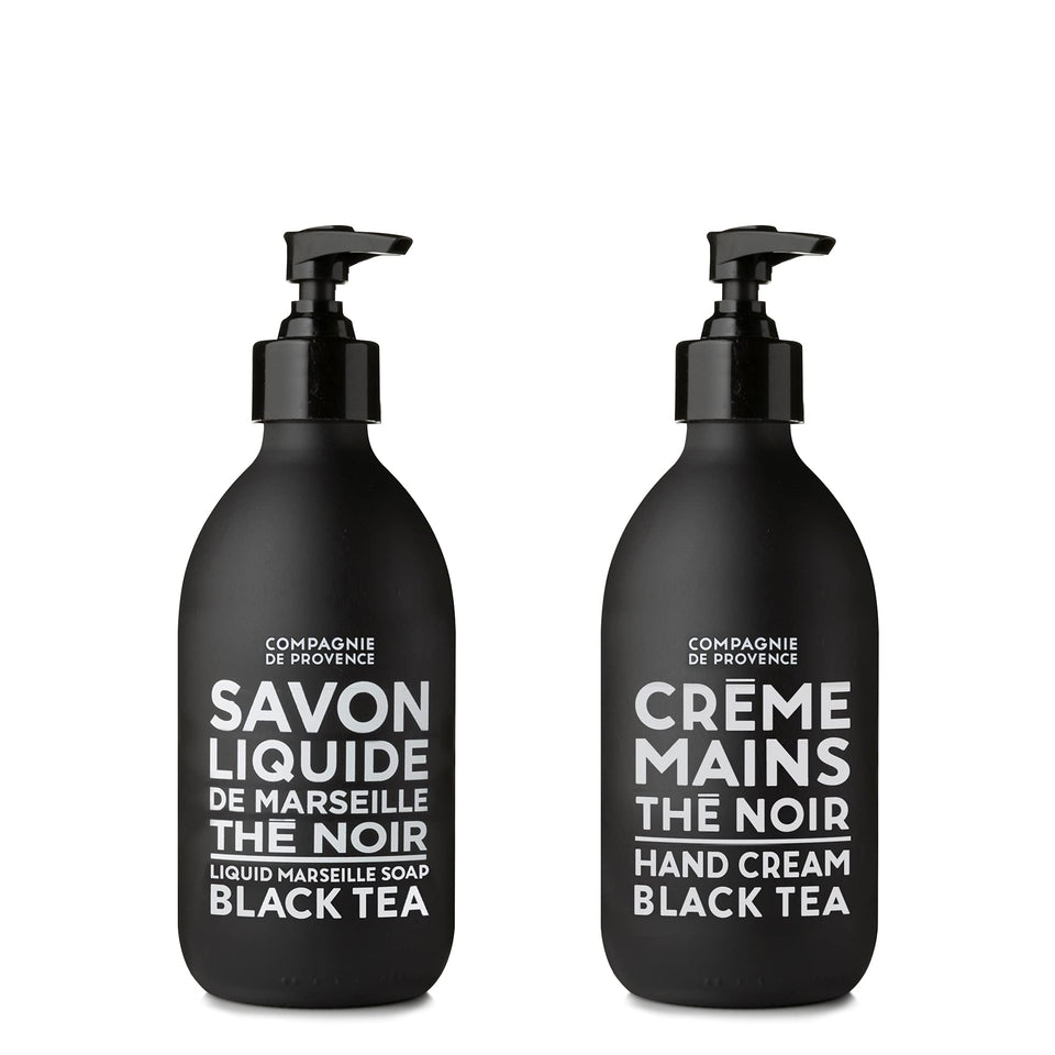 La Compagnie de Provence Black Tea liquid soap bottle on sink for refreshing cleansing.