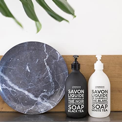 La Compagnie de Provence lacquered glass bottle in a modern bathroom.