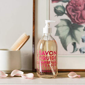 Glass bottle close-up reveals 97% natural-origin formula for skin-friendly care.