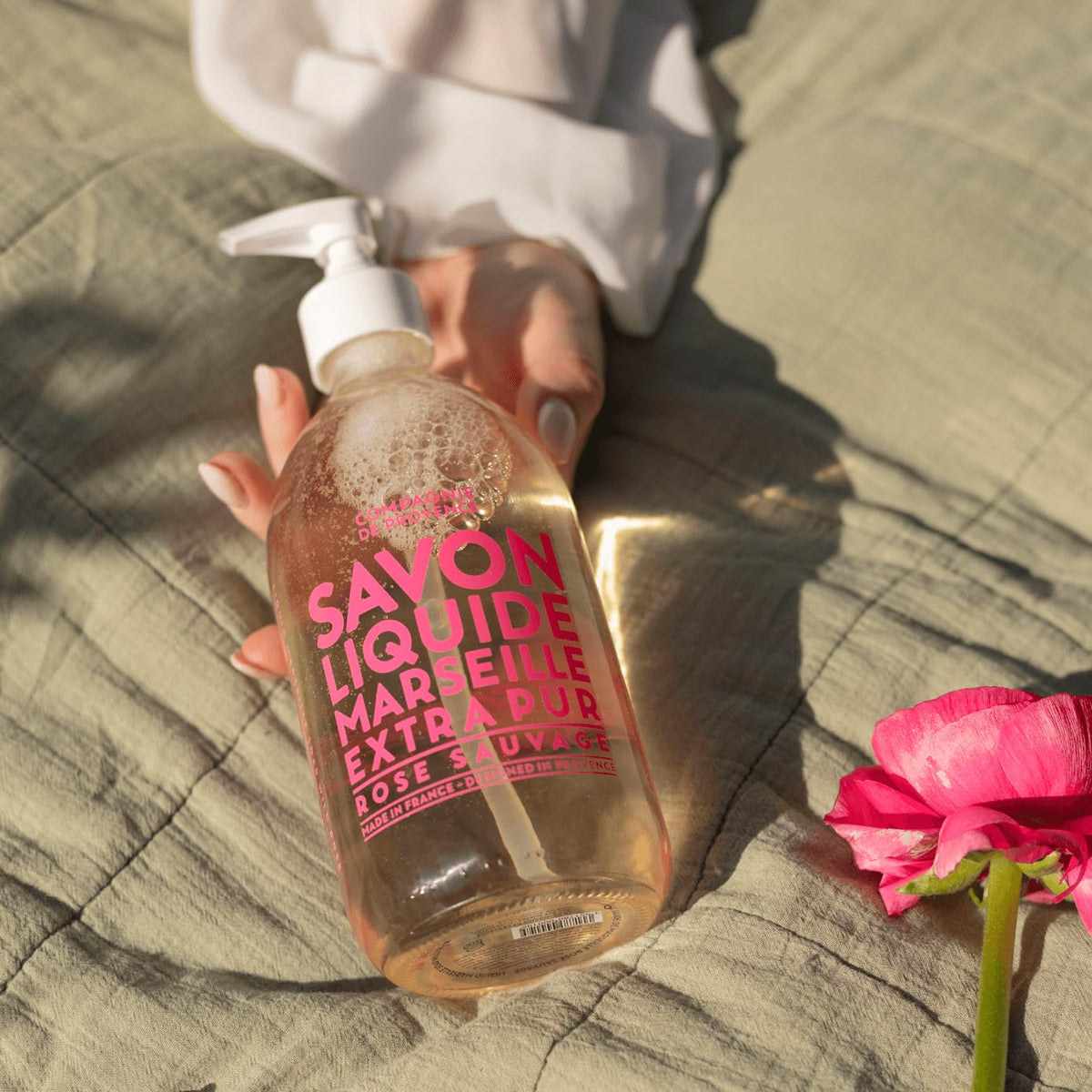 La Compagnie de Provence bottle on bathroom counter, highlighting graceful floral fragrance.