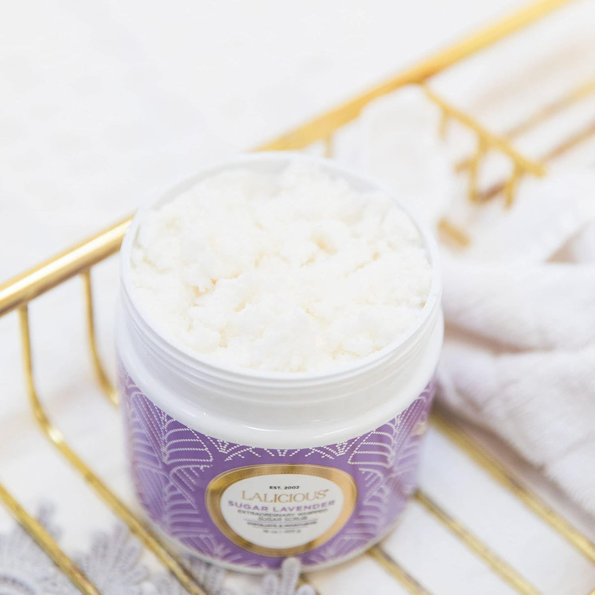 LALICIOUS Sugar Lavender exfoliating scrub application on skin for shave prep.