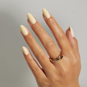 LAMIMOSA butter-yellow press-on nails in short almond shape for an easy, radiant spring manicure.