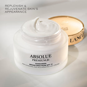 Lancôme Absolue Premium BX Day Cream jar with Pro-Xylane skincare infographic.