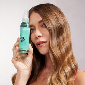 L'ANGE HAIR Sea Salt Texturizing Spray bottle on vanity with kelp-derived care.