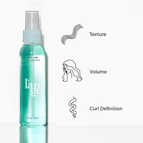 L'ANGE HAIR Sea Salt Texturizing Spray bottle close-up shows mineral-infused formula benefit.