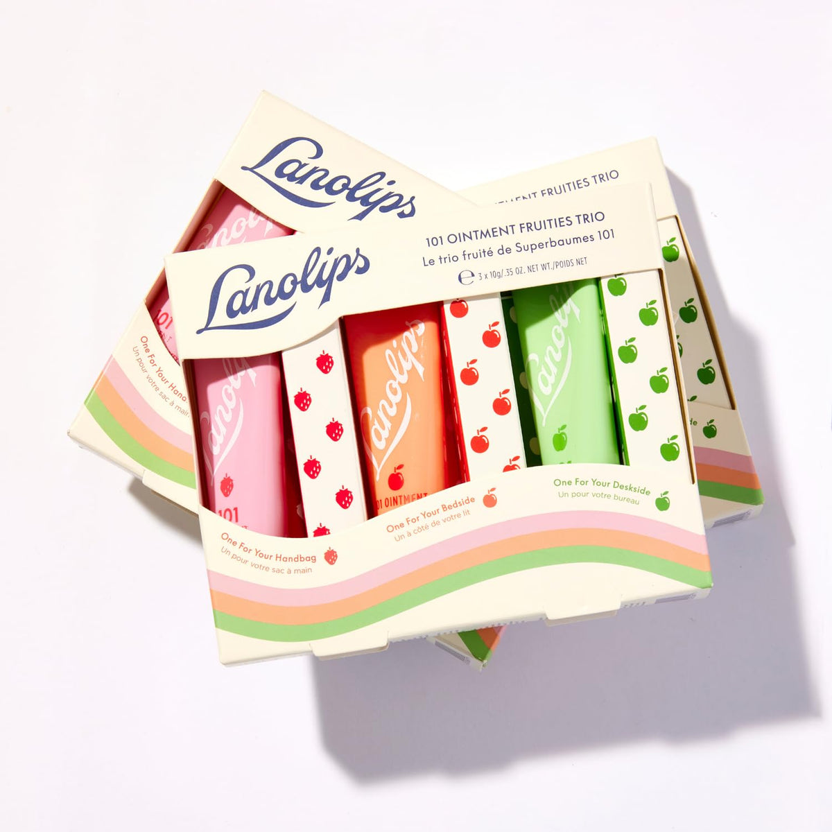 Lanolips green apple tin open at an angle displaying glossy balm surface