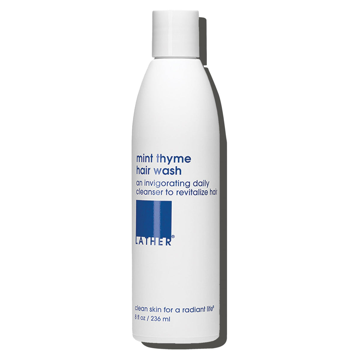 LATHER Mint Thyme Hair Wash bottle pour delivers a refreshing cleanse.