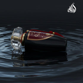 Lattafa Mohra bottle on surface, sleek unisex fragrance for any occasion
