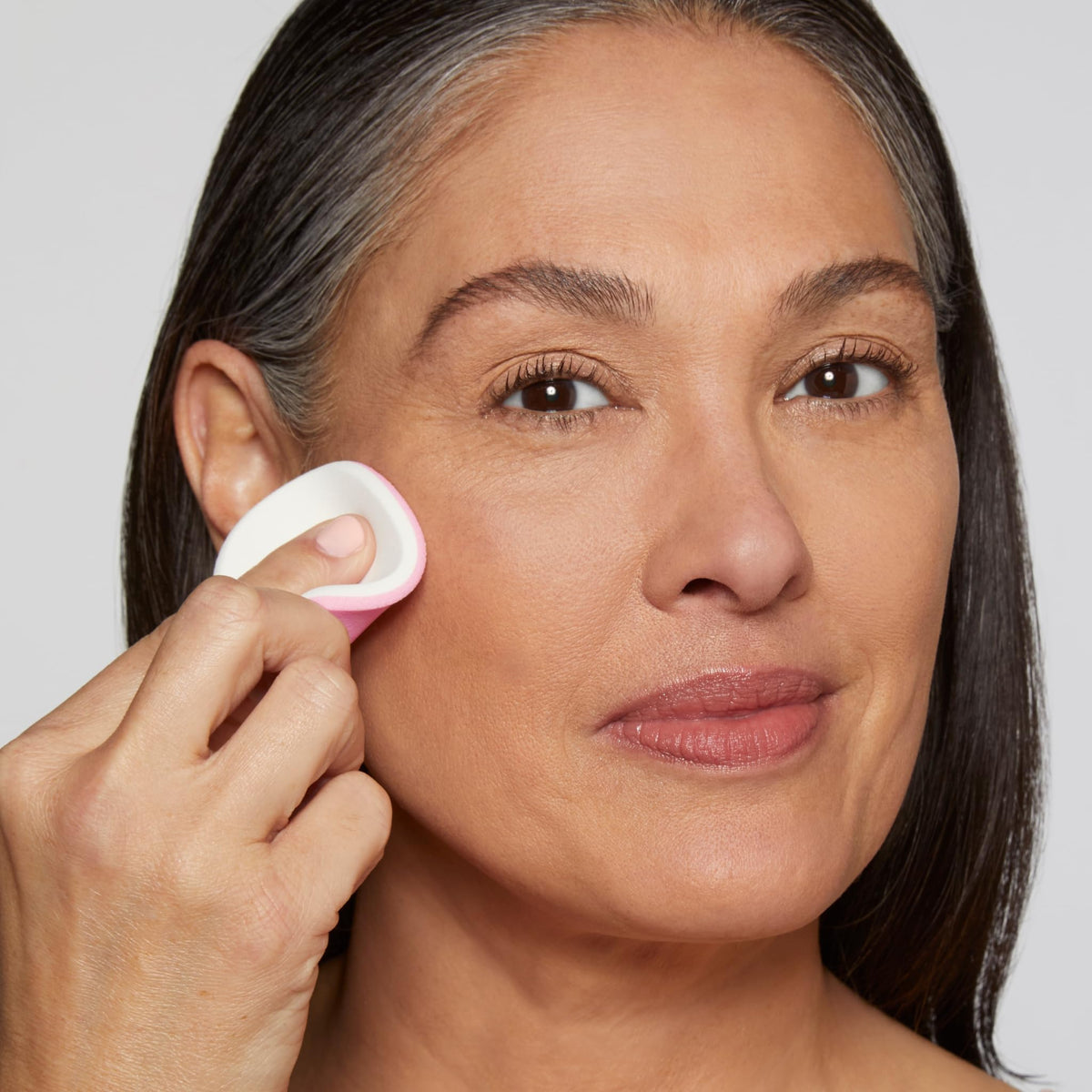 LAURA GELLER Double Take white-side sponge, damp for fuller coverage.