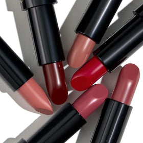 Laura Geller Modern Classic Lipstick Berry Bliss on lips showing creamy finish.