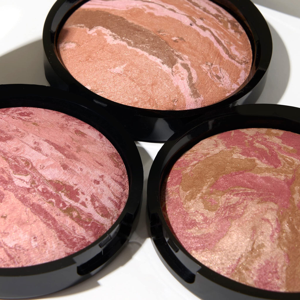 LAURA GELLER NEW YORK berry bronze shade swatch creates natural luminous blush