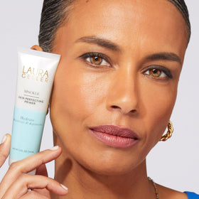 LAURA GELLER NEW YORK Foundation application close-up showing buildable coverage.